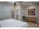 Bright bedroom featuring a bed, a dresser, a ceiling fan, and two windows providing natural light at 2011 Hamorton Pl, Charlotte, NC 28205