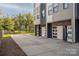 Modern townhome with attached garages and stylish gray and white exterior, plus a long driveway at 2011 Hamorton Pl, Charlotte, NC 28205