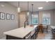 Bright kitchen features a large island with a white countertop, pendant lighting, and stainless steel appliances at 2011 Hamorton Pl, Charlotte, NC 28205