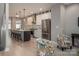 Bright open kitchen with stainless steel appliances, light cabinetry, a spacious island and hardwood floors at 2011 Hamorton Pl, Charlotte, NC 28205