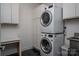 Clean laundry room features a stacked washer and dryer and a utility sink at 2011 Hamorton Pl, Charlotte, NC 28205