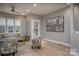 A comfortable living room with hardwood floors, gray walls, modern furniture, and natural light coming from big windows at 2011 Hamorton Pl, Charlotte, NC 28205