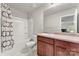 Well-lit bathroom featuring a white vanity, a mirror, and a shower with a patterned curtain at 2025 Slater Rd, Charlotte, NC 28216