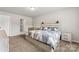 Comfortable bedroom featuring stylish decor, a headboard with sconces, and plush carpeting at 2025 Slater Rd, Charlotte, NC 28216