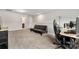 A comfortable bonus room area with a sofa, desk and computer at 2025 Slater Rd, Charlotte, NC 28216