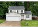A gray two-story home with an attached garage and lush front lawn at 2025 Slater Rd, Charlotte, NC 28216