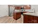 Modern kitchen with stainless steel appliances, wooden cabinets, and granite countertops at 2025 Slater Rd, Charlotte, NC 28216