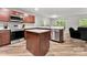 Modern kitchen with stainless steel appliances, wood cabinets, granite countertops, and wood flooring at 2025 Slater Rd, Charlotte, NC 28216