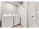 Convenient laundry room with washer, dryer, and shelving for organized storage at 2025 Slater Rd, Charlotte, NC 28216