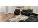 Spacious living room with wood floors, comfortable seating, and view of the kitchen at 2025 Slater Rd, Charlotte, NC 28216