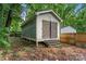 Exterior of an outdoor storage shed in the backyard with weathered wood steps at 2025 Slater Rd, Charlotte, NC 28216