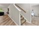 Carpeted staircase leading upstairs to a bedroom with a comfortable-looking bed at 2025 Slater Rd, Charlotte, NC 28216