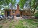 Relaxing backyard featuring patio furniture, lush lawn, and mature trees at 2026 Knell Dr, Charlotte, NC 28212