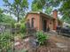 Inviting backyard with a brick house, a lush garden, and a cozy patio at 2026 Knell Dr, Charlotte, NC 28212
