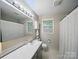 Bathroom featuring a white sink, framed mirror, and bright natural lighting at 2026 Knell Dr, Charlotte, NC 28212
