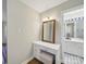 Vanity area leading to a bathroom with white cabinets and black-and-white tiled floor at 2026 Knell Dr, Charlotte, NC 28212