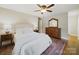 Comfortable bedroom with ceiling fan, hardwood floors, and a traditional-style dresser and mirror at 2026 Knell Dr, Charlotte, NC 28212