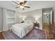 Bright bedroom with a large window, ceiling fan and hardwood floors at 2026 Knell Dr, Charlotte, NC 28212