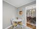 Cozy breakfast nook with a view to the dining room and decorated with a modern art piece and white table at 2026 Knell Dr, Charlotte, NC 28212