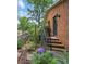 Charming brick home with a garden and blooming hydrangeas, accessible by a brick pathway and stairs at 2026 Knell Dr, Charlotte, NC 28212