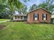 Well-maintained brick home with green lawn and manicured landscaping at 2026 Knell Dr, Charlotte, NC 28212