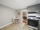 Kitchen features a dining table set, gray cabinets and access to the dining room, creating an efficient layout at 2026 Knell Dr, Charlotte, NC 28212