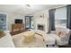 Cozy living room showcasing a white fireplace, a comfortable armchair, and an open view to the yard at 2026 Knell Dr, Charlotte, NC 28212