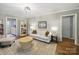 Comfortable living room featuring a sofa, chair, bookshelves, hardwood floors and neutral color scheme at 2026 Knell Dr, Charlotte, NC 28212