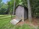 A backyard outbuilding with a ramp offers additional storage and workspace for outdoor projects at 2026 Knell Dr, Charlotte, NC 28212