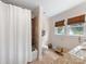 Bright bathroom features a shower, tile flooring, and a window for natural light at 2112 Chatham Ave, Charlotte, NC 28205