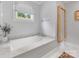 Relaxing bathtub with marble surround, stylish fixtures, and a serene view, perfect for unwinding at 2112 Chatham Ave, Charlotte, NC 28205
