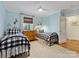 Charming bedroom with two twin beds, wood flooring, and natural light streaming through the window at 2112 Chatham Ave, Charlotte, NC 28205