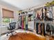 Spacious walk-in closet features custom shelving, drawers, and natural light from a nearby window at 2112 Chatham Ave, Charlotte, NC 28205