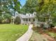 Beautifully landscaped front yard leading to a charming home with a covered front porch at 2112 Chatham Ave, Charlotte, NC 28205