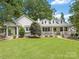 Charming white-painted brick home with a welcoming front porch and lush green lawn at 2112 Chatham Ave, Charlotte, NC 28205