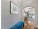 Stylish hallway with elegant blue bench, textured walls, and arched doorway leading to bedroom at 2112 Chatham Ave, Charlotte, NC 28205