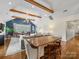Spacious living area showcasing vaulted ceiling, exposed beams, and an adjacent dining space at 2112 Chatham Ave, Charlotte, NC 28205