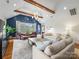 Inviting living room features vaulted ceiling, exposed beams, comfortable seating, and large windows at 2112 Chatham Ave, Charlotte, NC 28205