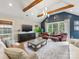 Spacious living room with high ceilings, exposed beams, and a cozy seating arrangement at 2112 Chatham Ave, Charlotte, NC 28205