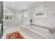 Luxurious main bathroom featuring soaking tub, glass-enclosed shower, and elegant fixtures at 2112 Chatham Ave, Charlotte, NC 28205