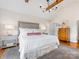 Comfortable main bedroom with vaulted ceiling, beams, neutral tones, and beautiful chandelier at 2112 Chatham Ave, Charlotte, NC 28205