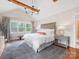 Inviting main bedroom with vaulted ceiling, exposed beams, large windows, and plush king-size bed at 2112 Chatham Ave, Charlotte, NC 28205