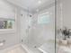 Modern shower with glass enclosure, white tile, and stylish fixtures, offering a spa-like experience at 2112 Chatham Ave, Charlotte, NC 28205