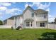 Back view of home, featuring a large, grassy backyard and patio area at 220 Otman Ct, Rock Hill, SC 29732