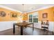 Bright dining room with a modern table, hardwood floors, wainscoting, and natural light at 220 Otman Ct, Rock Hill, SC 29732