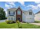 Attractive home boasting a two-car garage, a brick facade, and a lush green lawn at 220 Otman Ct, Rock Hill, SC 29732