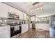 Bright kitchen features stainless steel appliances, white cabinetry and modern lighting fixtures at 220 Otman Ct, Rock Hill, SC 29732