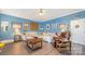 Spacious living room with hardwood floors, comfortable seating, and bright blue walls at 220 Otman Ct, Rock Hill, SC 29732