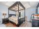 This main bedroom boasts a four-poster bed, tray ceilings, and wood-look flooring at 220 Otman Ct, Rock Hill, SC 29732