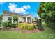 Beautiful backyard featuring a covered patio, lush landscaping, and a well-maintained lawn at 2213 Hartwell Ln # 84, Indian Land, SC 29707